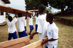 Students carrying lumber