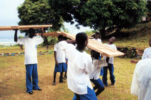 Students carrying lumber