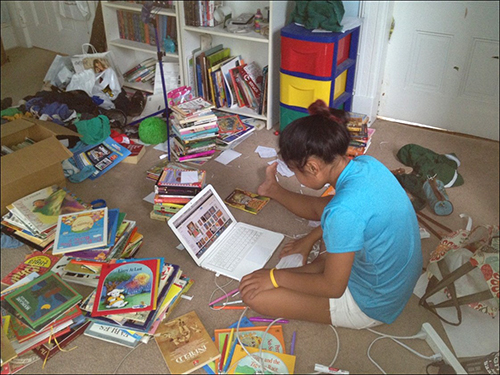 Georgia Howell cataloging donated books. 